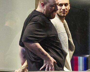 Singer Sam Smith steps out in miniskirt as he enjoys a stroll with his boyfriend Christian Cowan (photos)